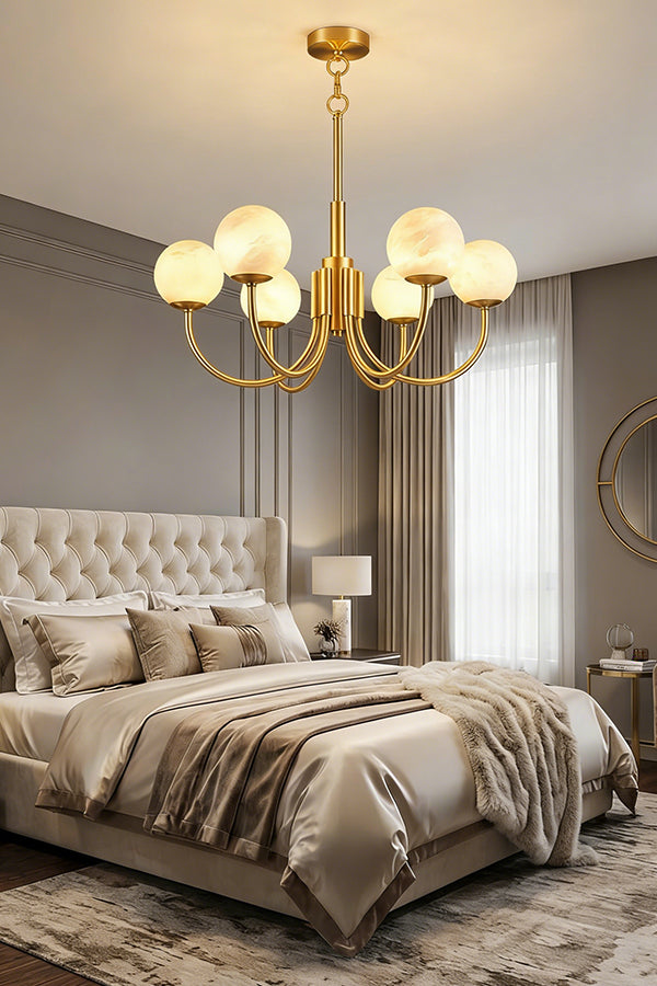 Modern brass chandelier with alabaster globes | Alabaster, Brass | Mounted in a bedroom above a bed with tufted headboard | Samu Lamp