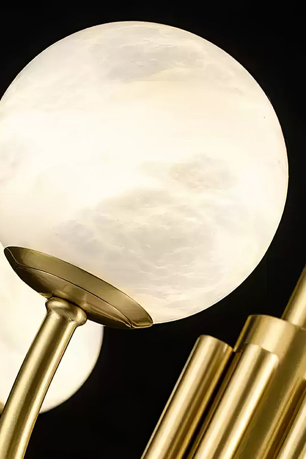 Detail of brass chandelier arms and globe base | Brass, Alabaster | Macro shot showing the metallic texture and stone | Samu Lamp