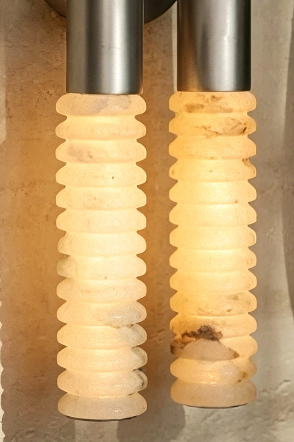 Monolith Arc Alabaster Wall Lamp | Alabaster, Metal | Macro view of the lit ribbed alabaster surface showing natural stone variations | Detail shot | Samu Lamp