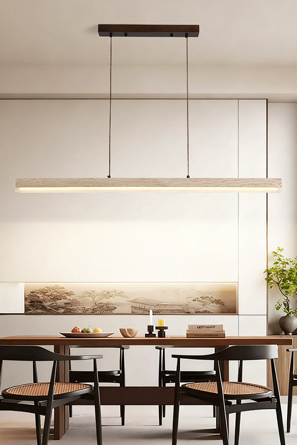 Lit linear travertine pendant over a set dining table | Travertine, Wood, Acrylic | Contemporary room with abstract wall art | Samu Lamp