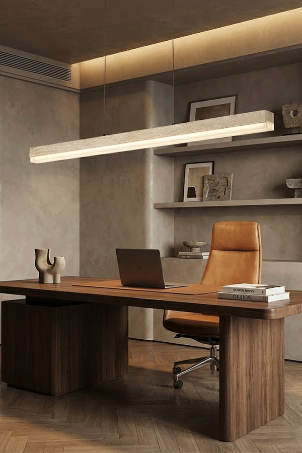Linear stone pendant light for home office | Travertine, Wood, Acrylic | Installed above a large wooden desk and leather chair | Samu Lamp