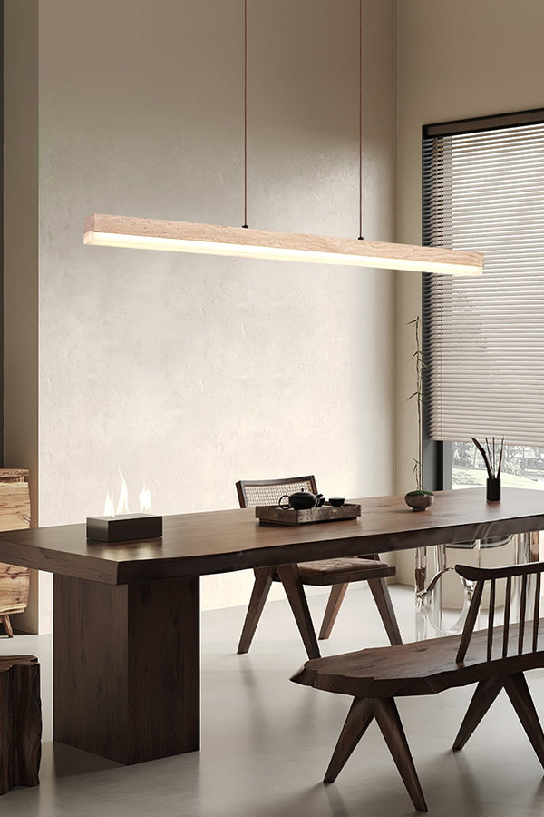 Minimalist travertine linear light fixture | Travertine, Wood, Acrylic | Over a dark wood dining table and bench | Samu Lamp