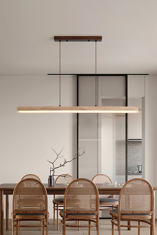 Linear travertine dining light over rattan chairs | Travertine, Wood, Acrylic | Interior scene in a warm contemporary dining room | Samu Lamp