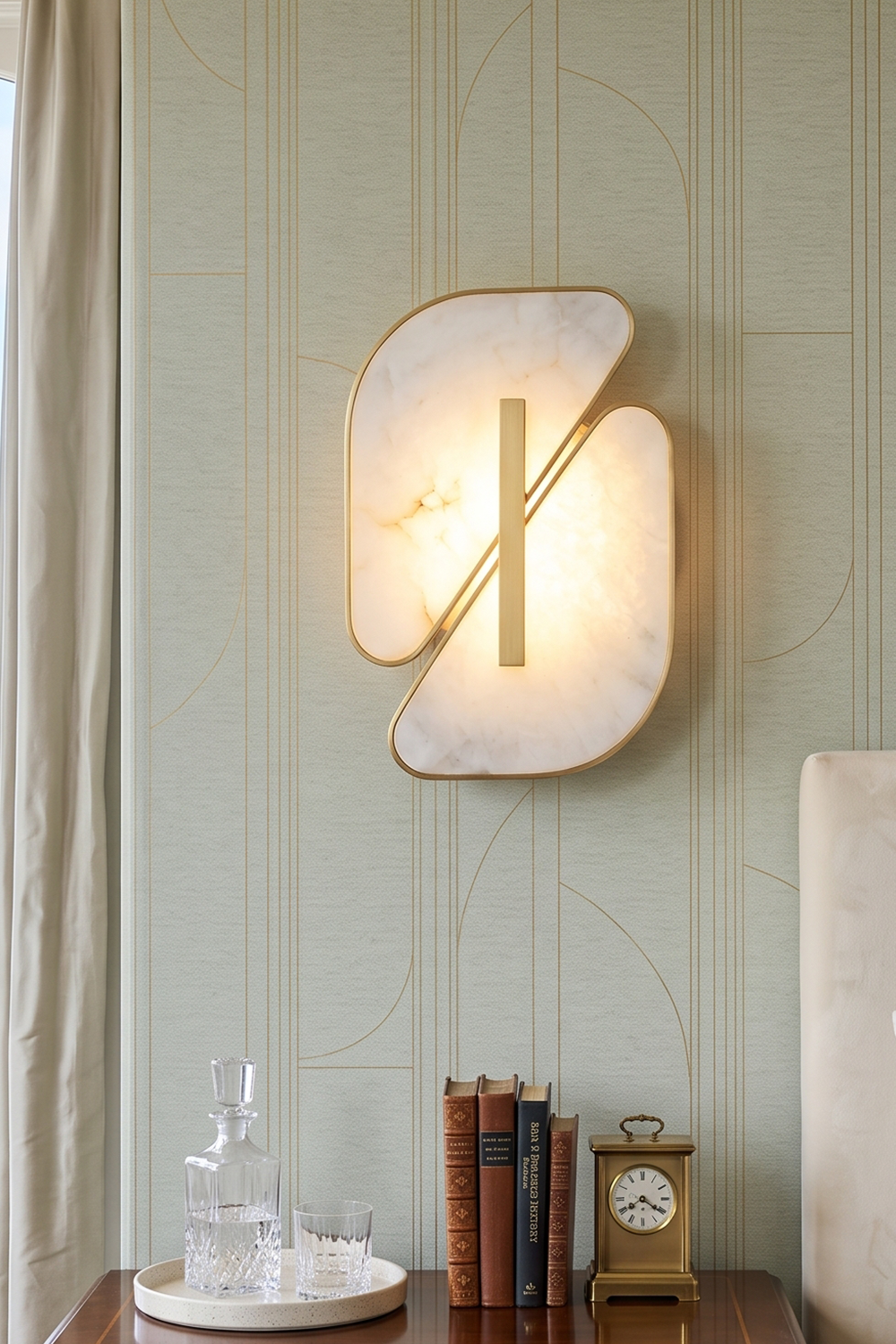 Nerine Overlapping Alabaster Wall Lamp displayed on a patterned wall, illuminating the space with elegant design.
