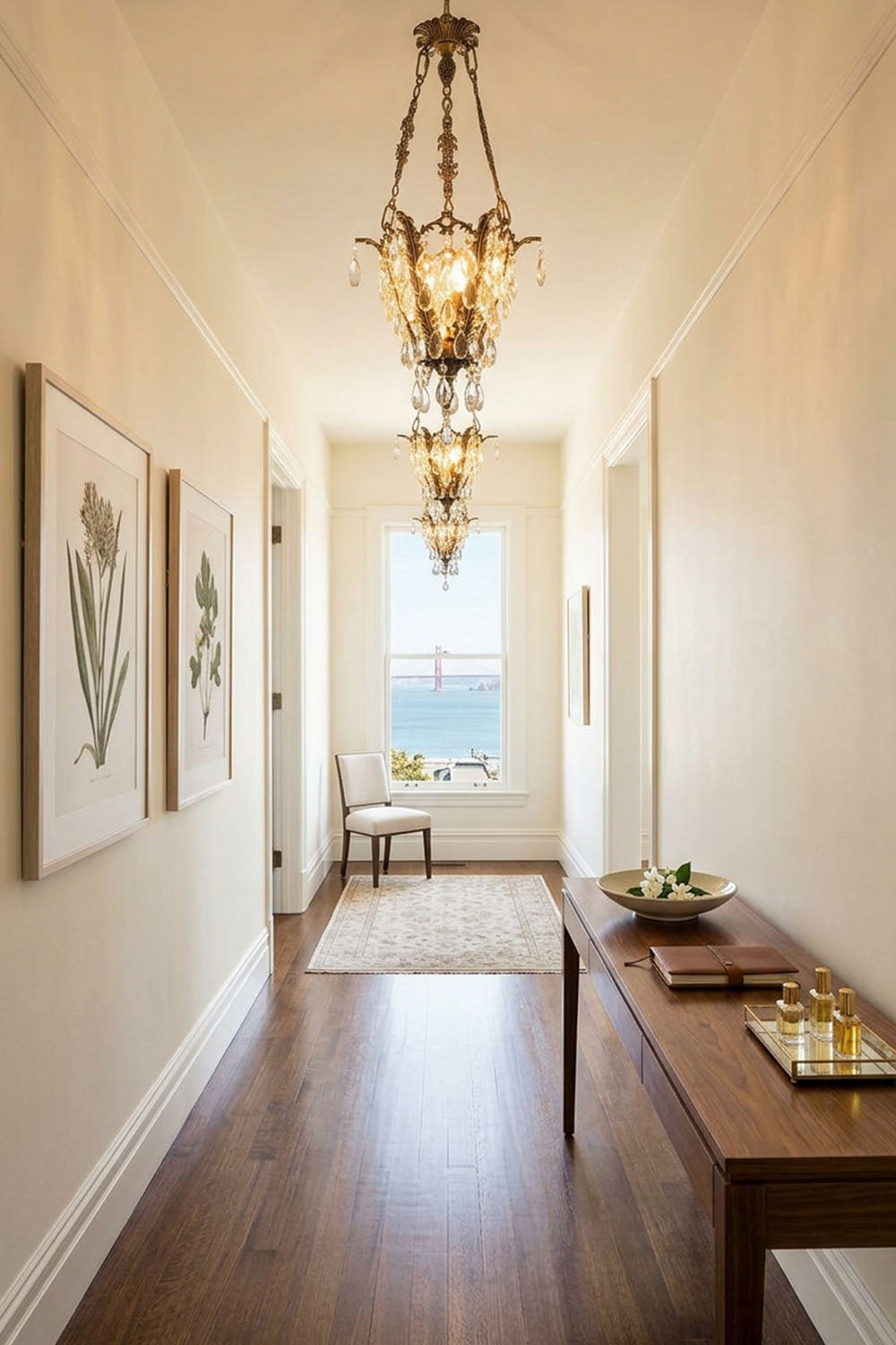 Ninon Crystal Basket Brass Pendant Light illuminating a stylish hallway with artwork and a scenic view.