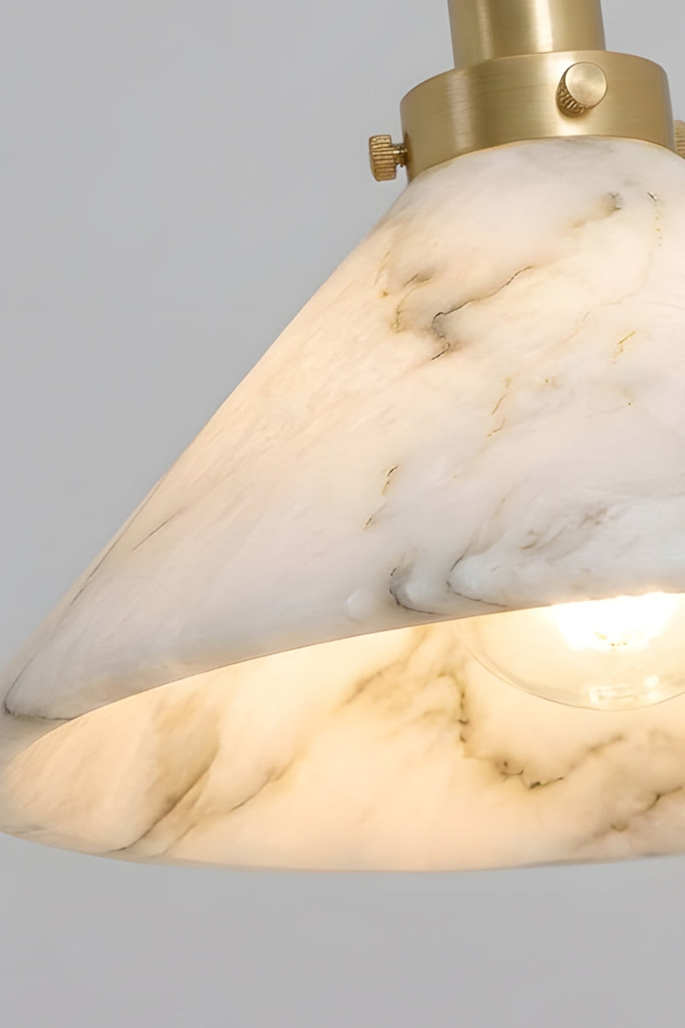 Odette Alabaster Curved Wall Sconce | Stone Texture Detail | Macro close-up view of the illuminated natural white alabaster stone shade displaying beautiful soft translucent grey veins | Detail shot | Samu Lamp