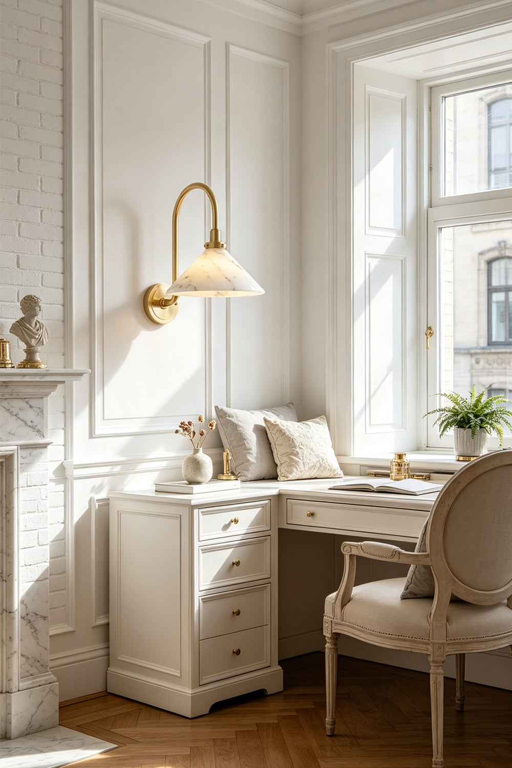 Odette Alabaster Curved Wall Sconce | Study Reading Sconce | Mounted as an elegant reading light on a white paneled wall above a classic writing desk and window bench in a bright home office | Samu Lamp