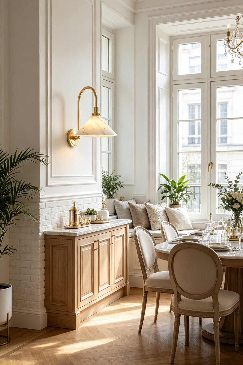 Odette Alabaster Curved Wall Sconce | Dining Area Wall Light | Positioned gracefully as sophisticated accent lighting above a wooden sideboard cabinet in a refined classical dining space | Samu Lamp