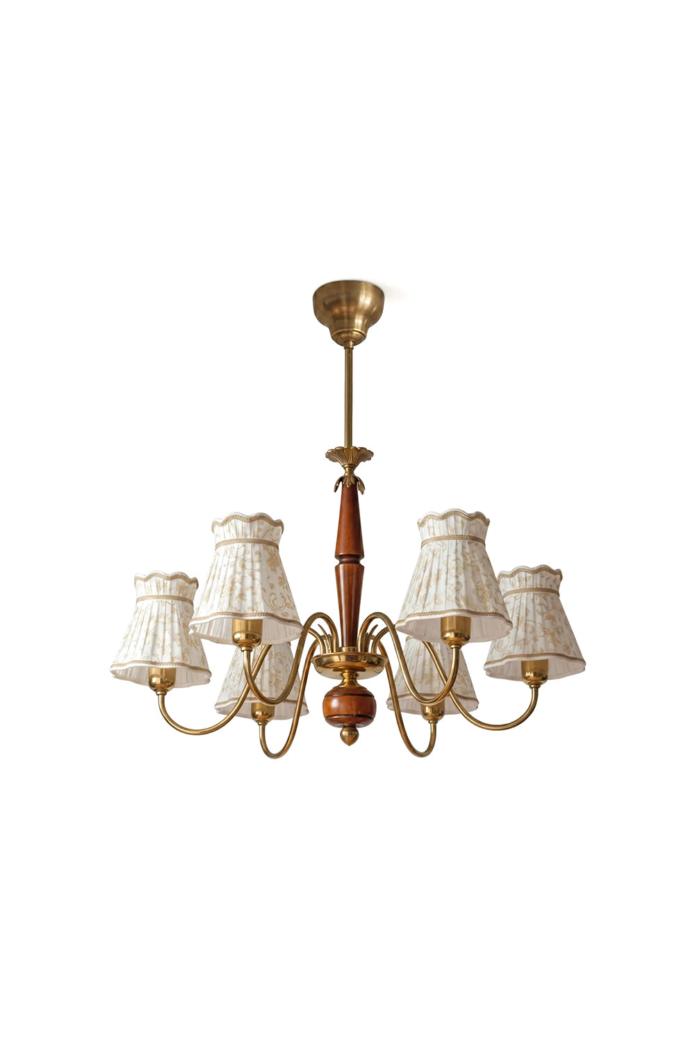 Odette Vintage Pleated Shaded Chandelier | Wood, Brass, Fabric | Isolated unlit view of a traditional 6-arm vintage chandelier featuring cream pleated fabric shades, curved brass scroll arms, and a turned wood central spindle column | White background | Samu Lamp
