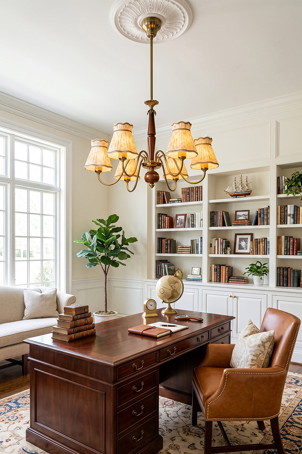 Odette Vintage Pleated Shaded Chandelier | Wood, Brass, Fabric | Placed as a statement light fixture in a classic home office or library space above a large dark wood executive desk and leather chair | Samu Lamp