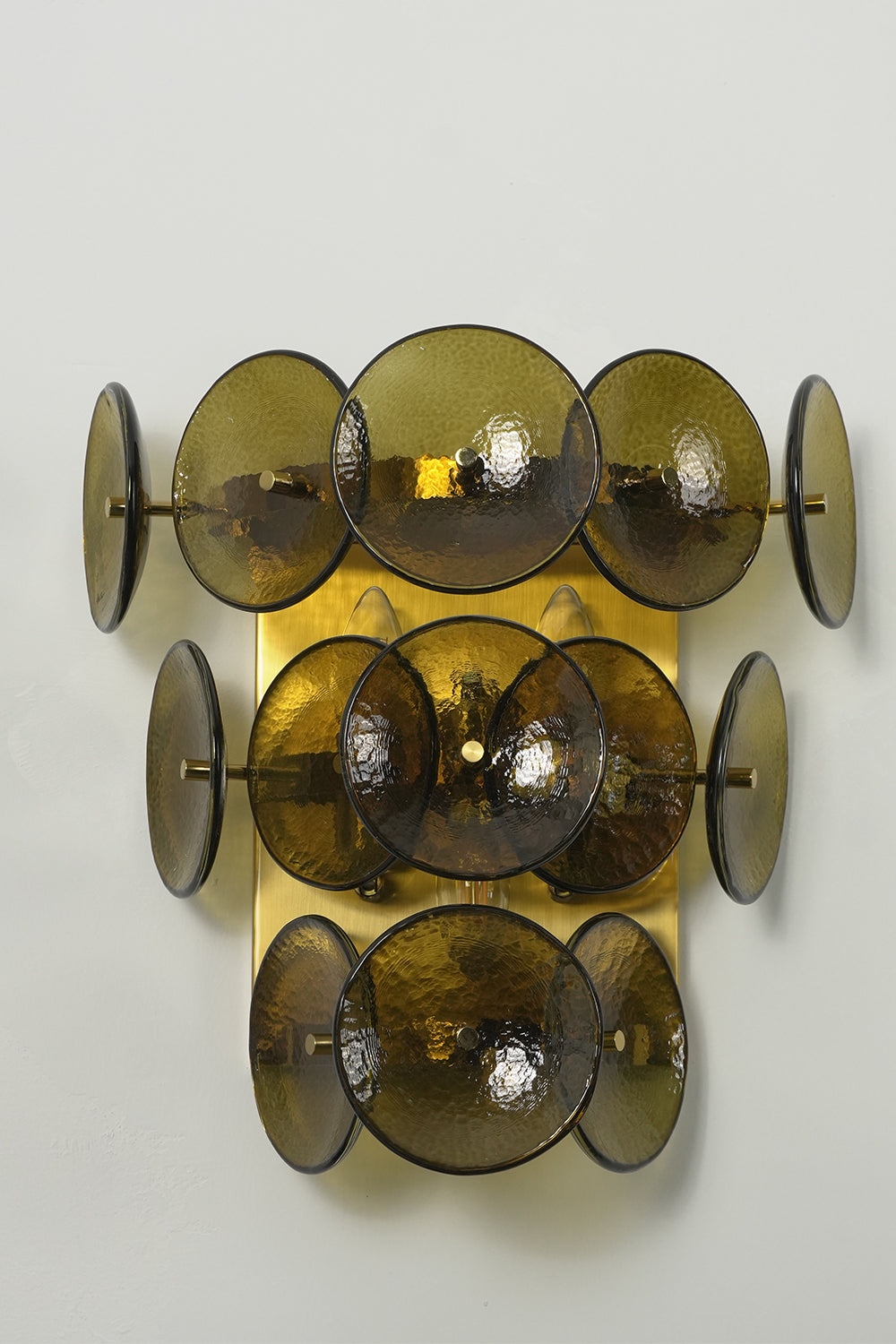 Unlit olive green glass disc wall lamp with tiered structure | Metal, Glass | Angled product view | Samu Lamp