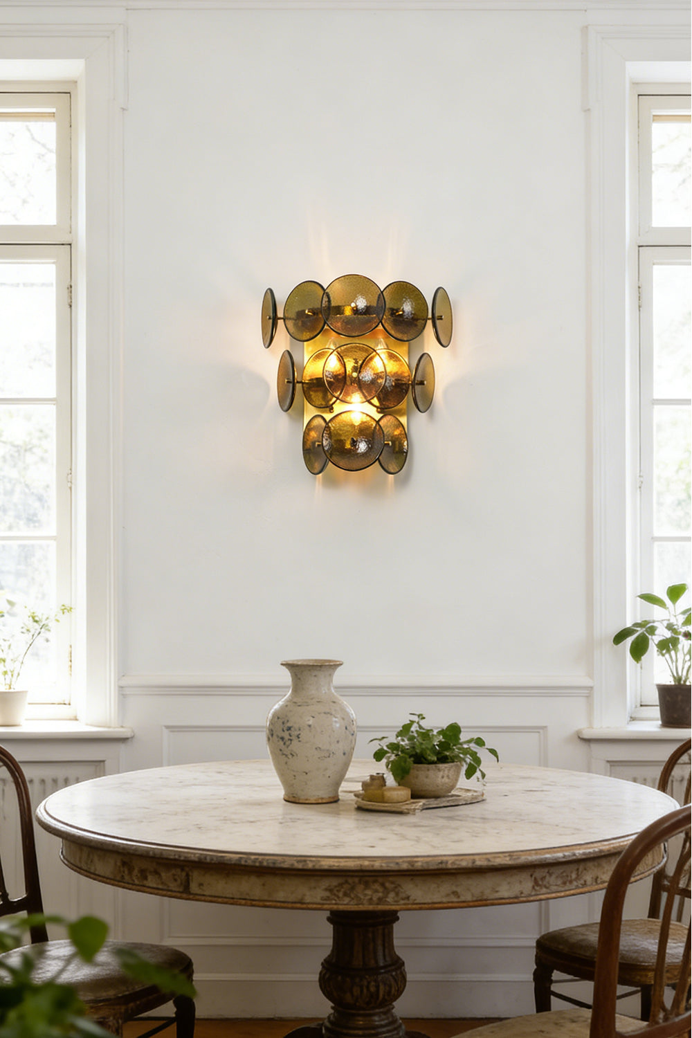 Close-up detail of lit hammered green glass discs | Glass, Metal | Showing hammered texture and warm light glow | Samu Lamp