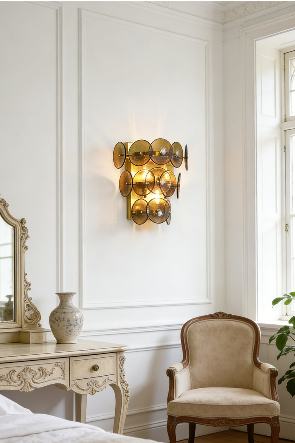Lit tiered olive green wall light | Metal, Glass | Installed in a traditional living area near white wainscoting | Samu Lamp