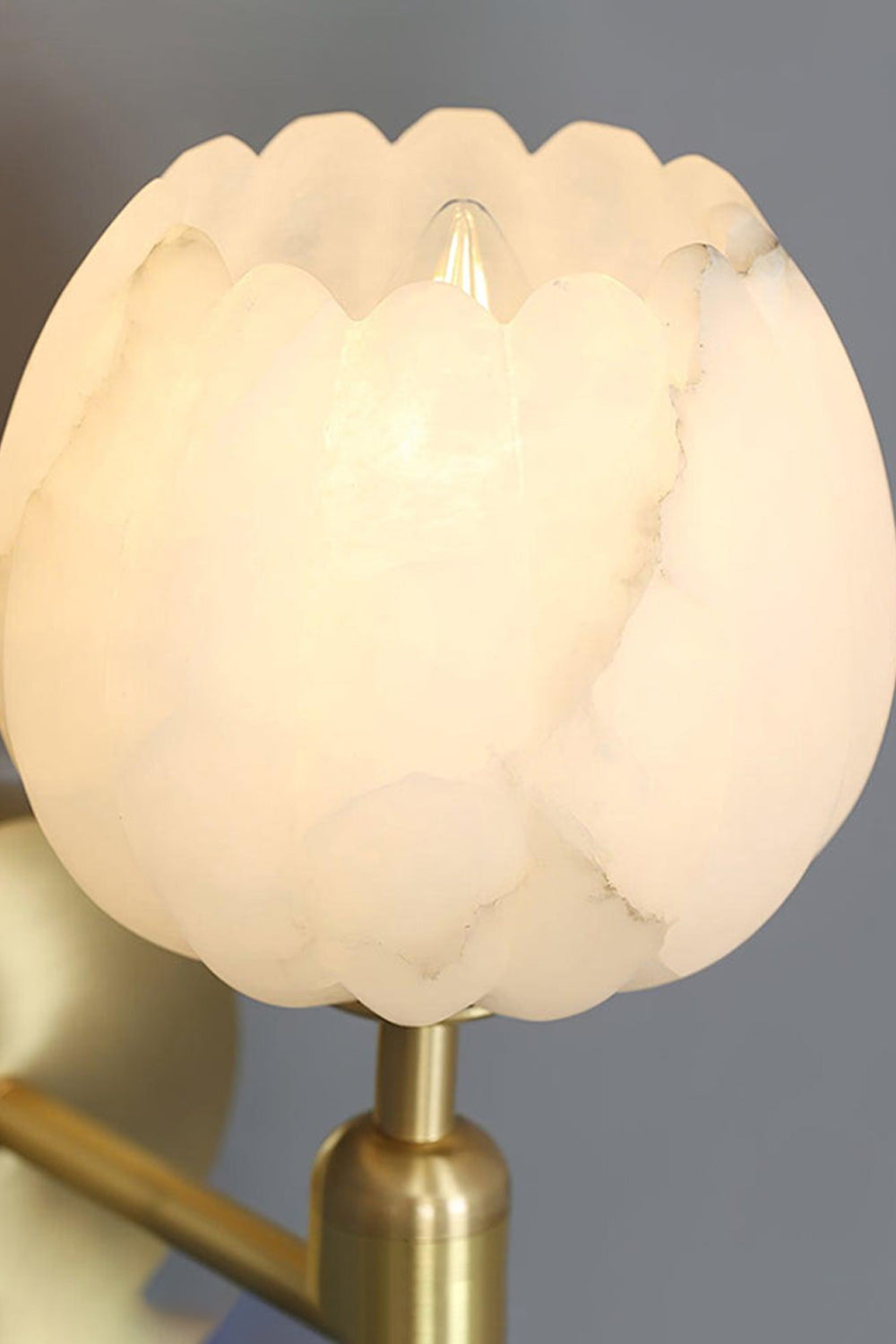 Ondine Alabaster Blossom Wall Sconce | Natural Alabaster and Brass | Positioned in a sophisticated home office study room over a classic wooden desk and bookshelf | Samu Lamp