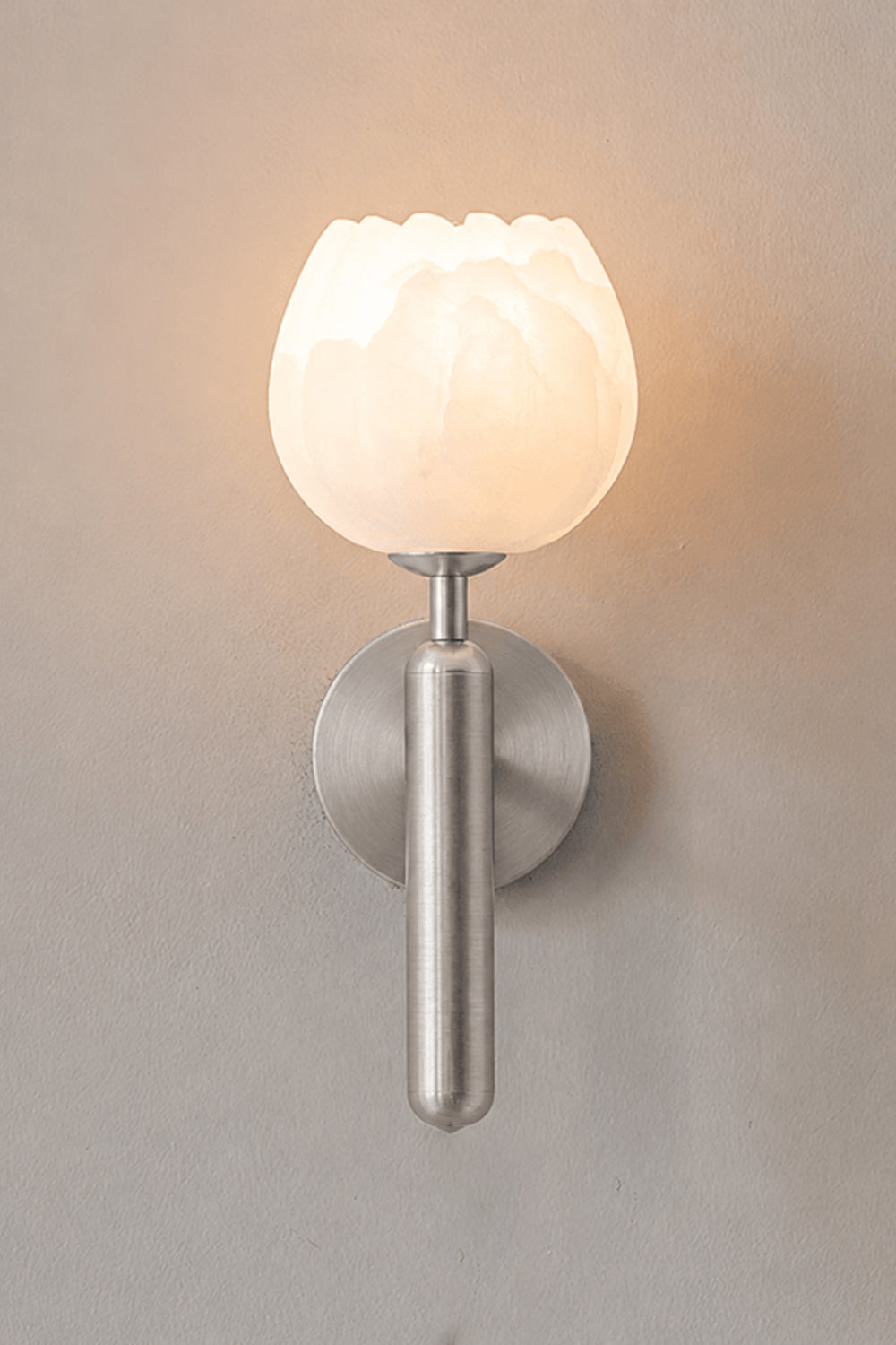 Ondine Alabaster Blossom Wall Sconce | Natural Alabaster and Chrome Metal | Single product shot showing the lit stone flower fixture with a polished silver chrome finish option | Samu Lamp