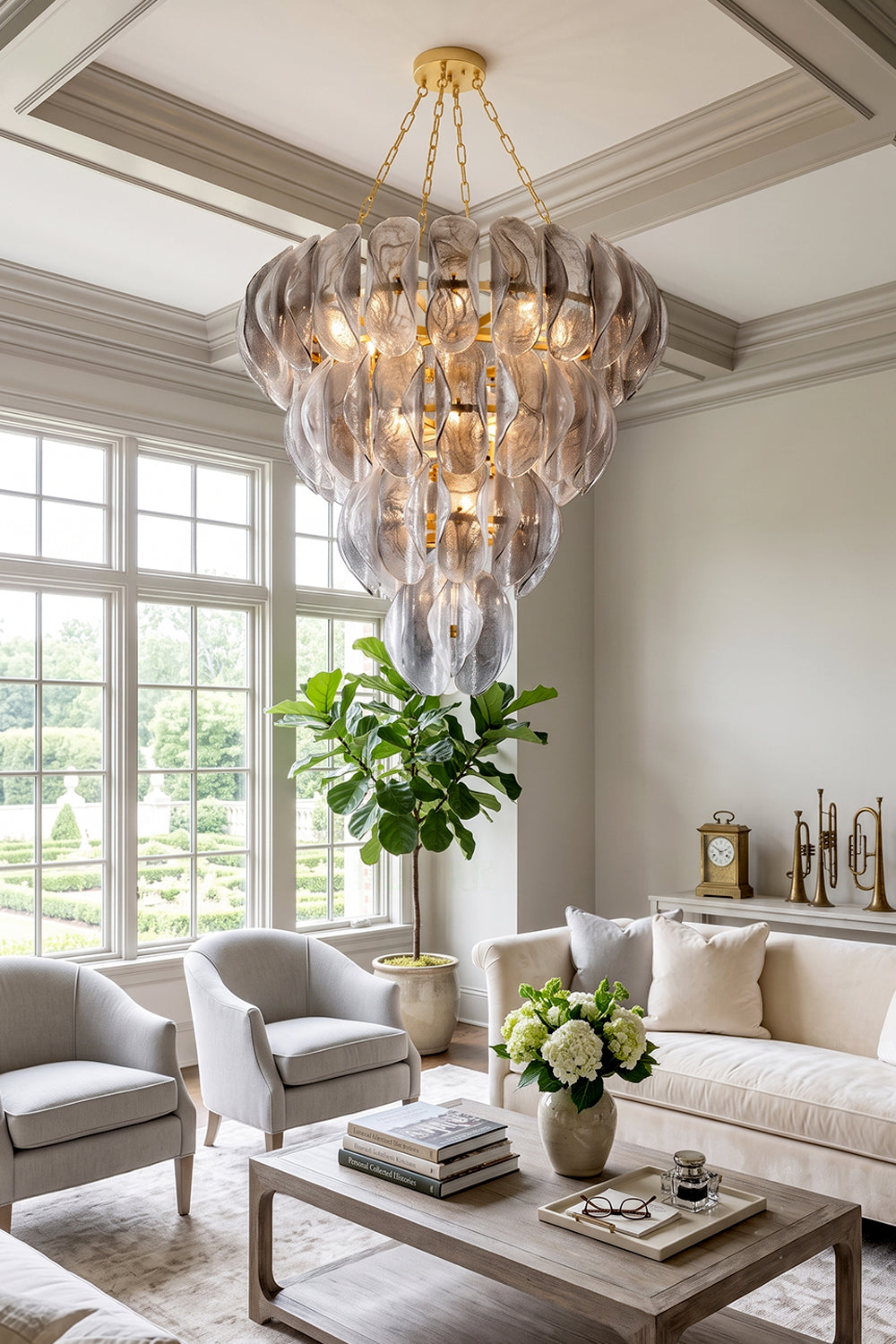 Ondine Cascading Leaf Glass Chandelier | Textured Smoked Glass and Gold Metal | Styled under a coffered ceiling in a spacious bright living room with elegant grey fabric sofas | Samu Lamp