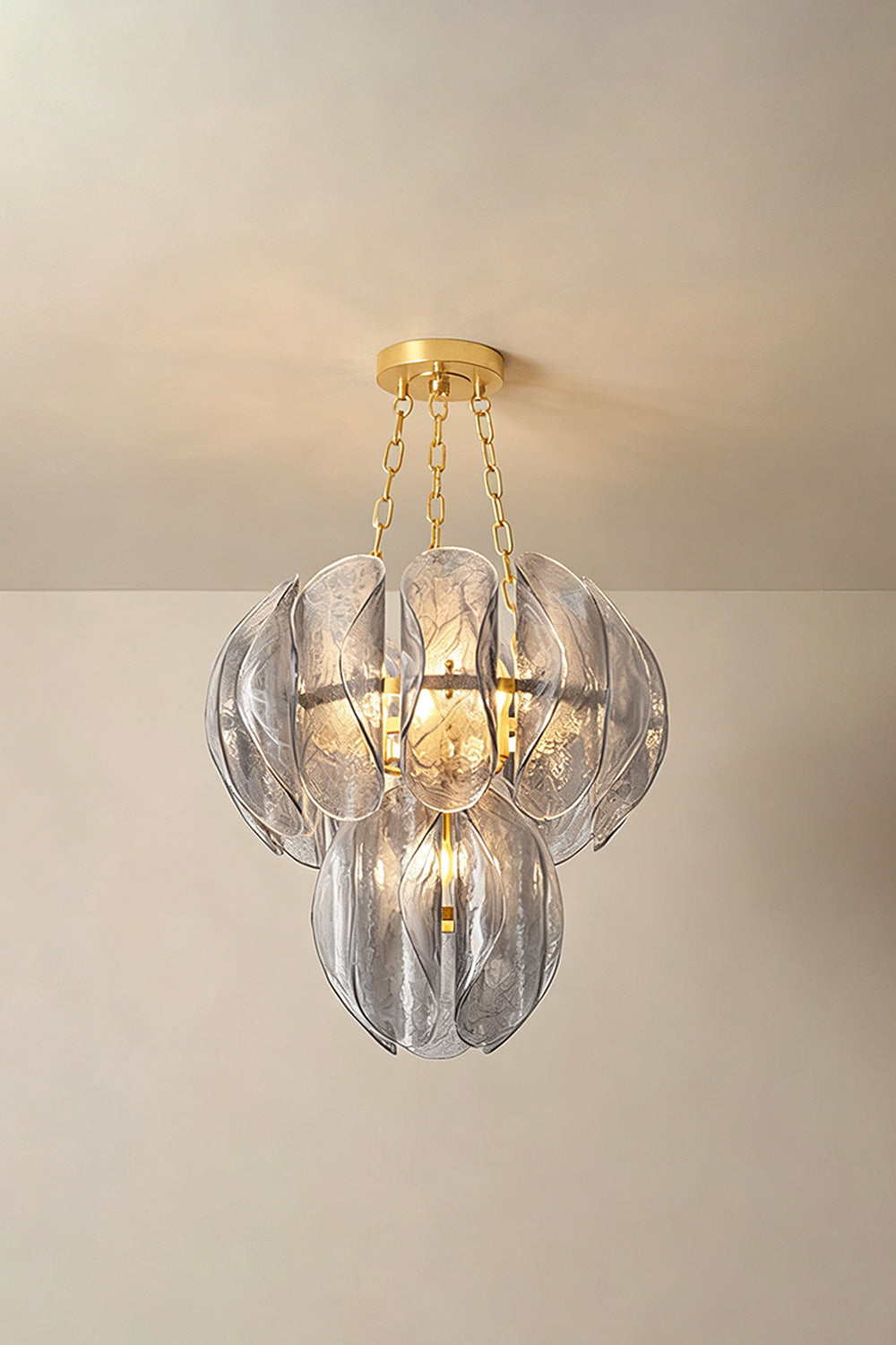 Ondine Cascading Leaf Glass Chandelier | Textured Smoked Glass and Gold Metal | Standard perspective view showcasing the glowing multi-layered leaf arrangement against a warm neutral wall | Samu Lamp