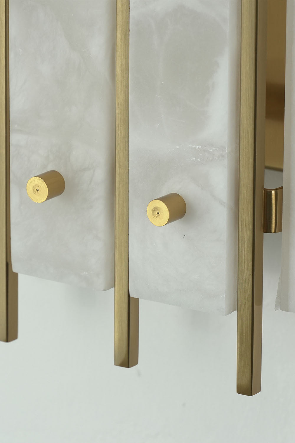 Ondrelle Bar Wall Sconce | Solid Brass Hardware | Close-up of brass end bars and round fixing screw caps | Samu Lamp