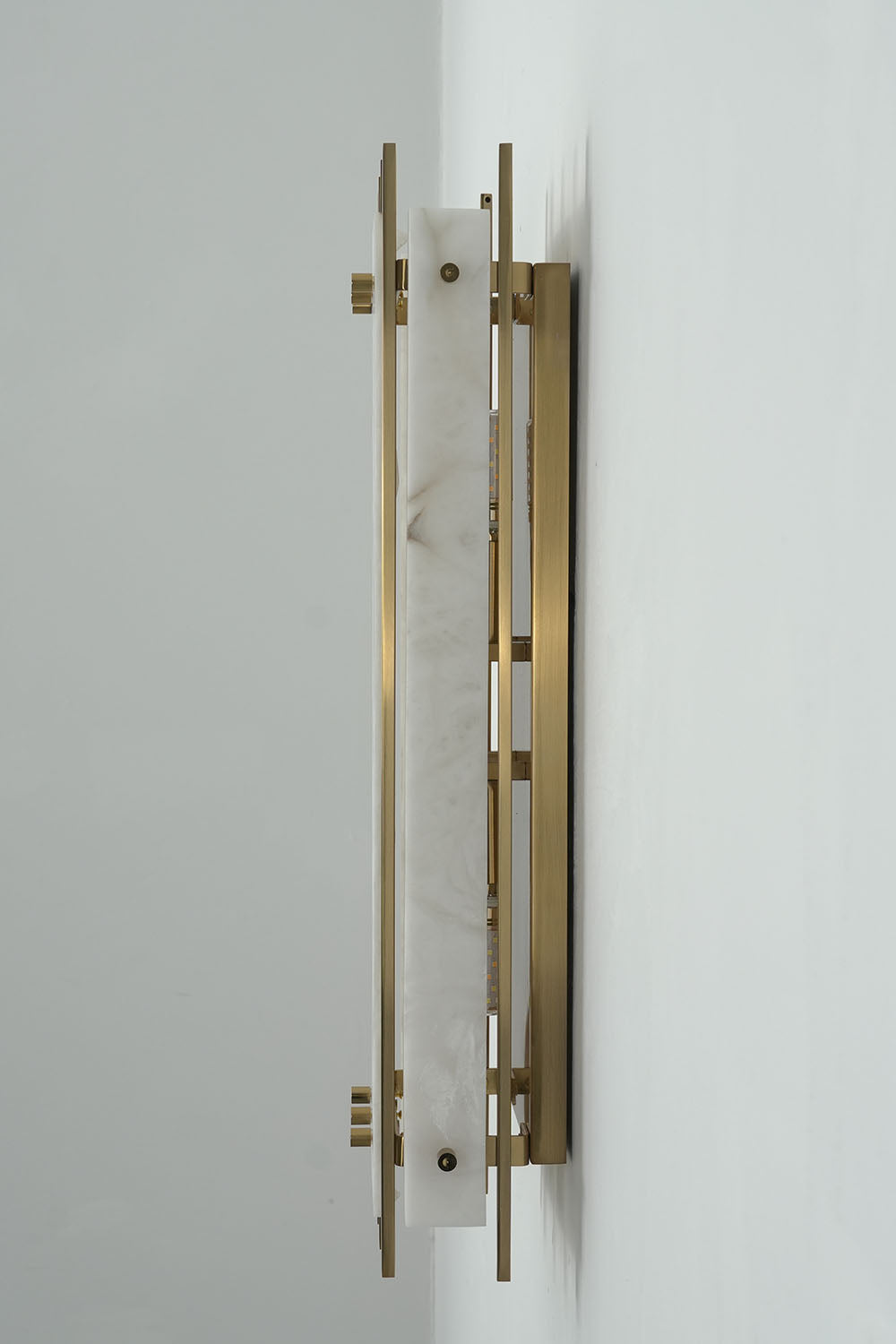 Ondrelle Bar Wall Sconce | Alabaster and Brass | Side profile view mounted on wall showing depth and plate | Samu Lamp