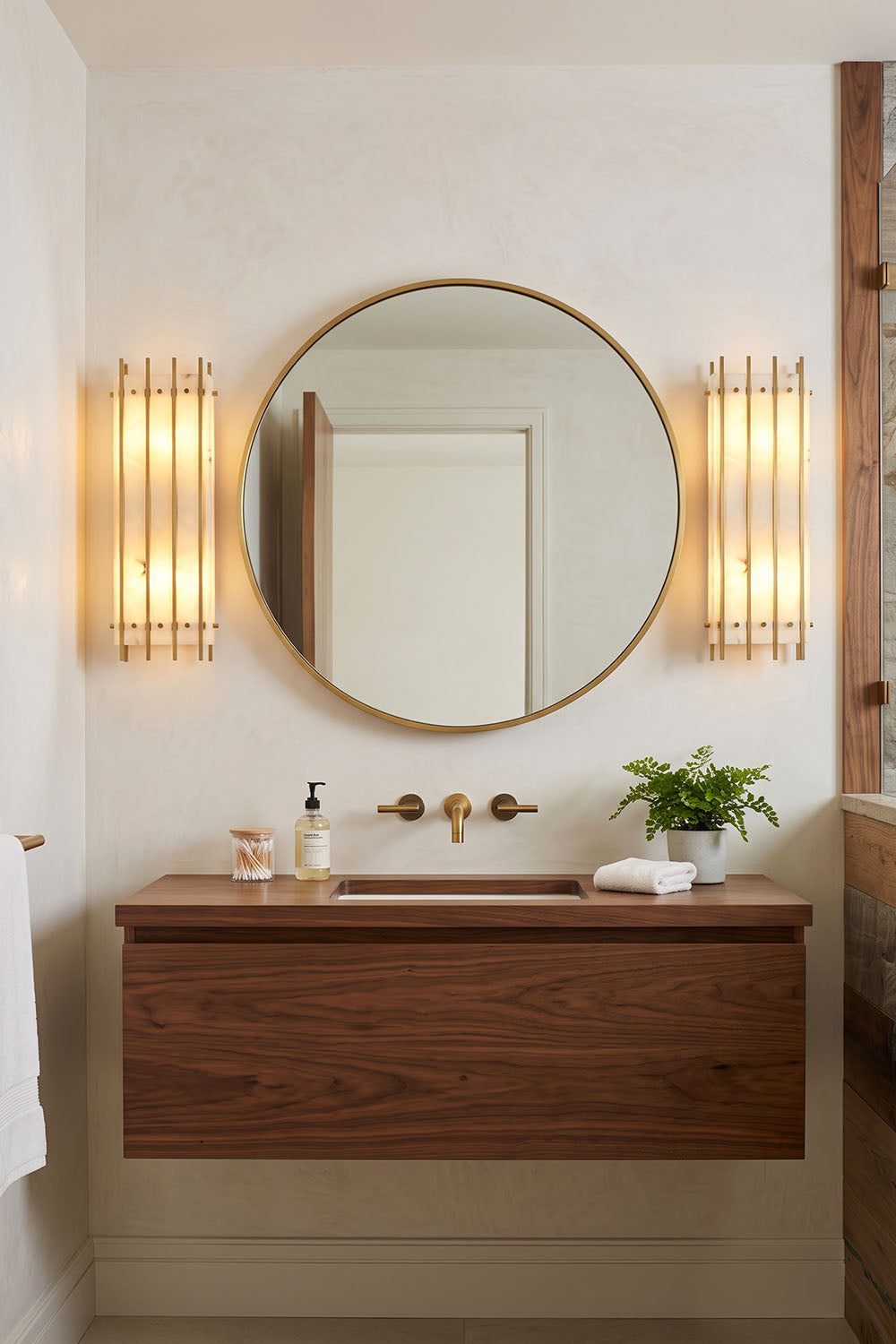 Ondrelle Bar Wall Sconce | Alabaster and Brass | Flanking a circular mirror in a minimalist wooden bathroom | Samu Lamp