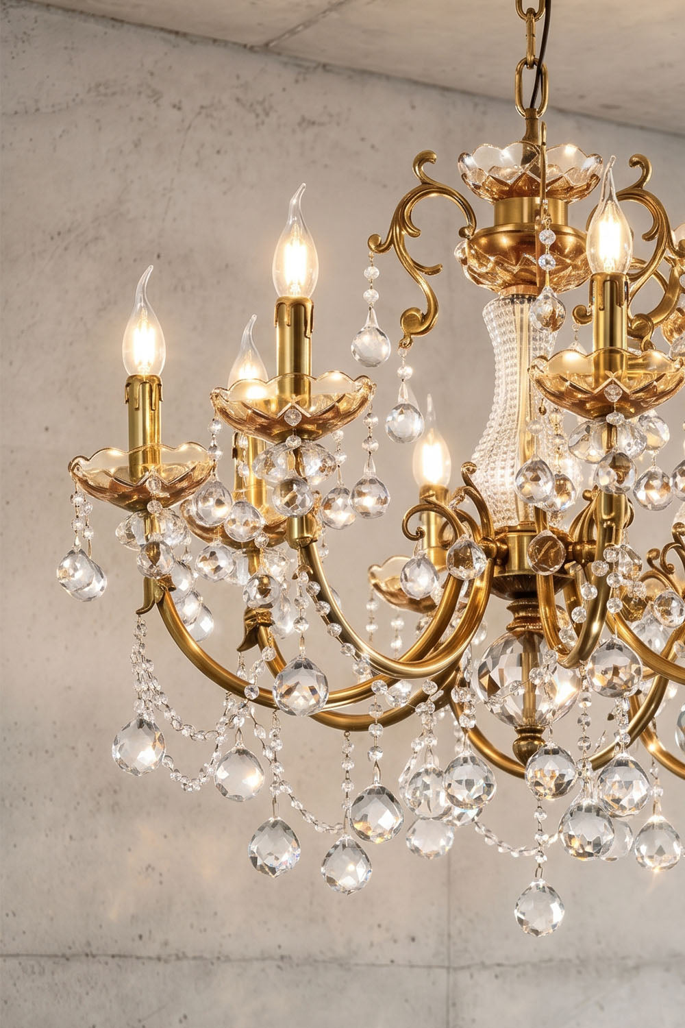 Orbessan Brass Crystal Oval Candle Chandelier | Cut Crystal and Brass | Close-up shot of glowing candle lights and dangling crystal beads | Samu Lamp