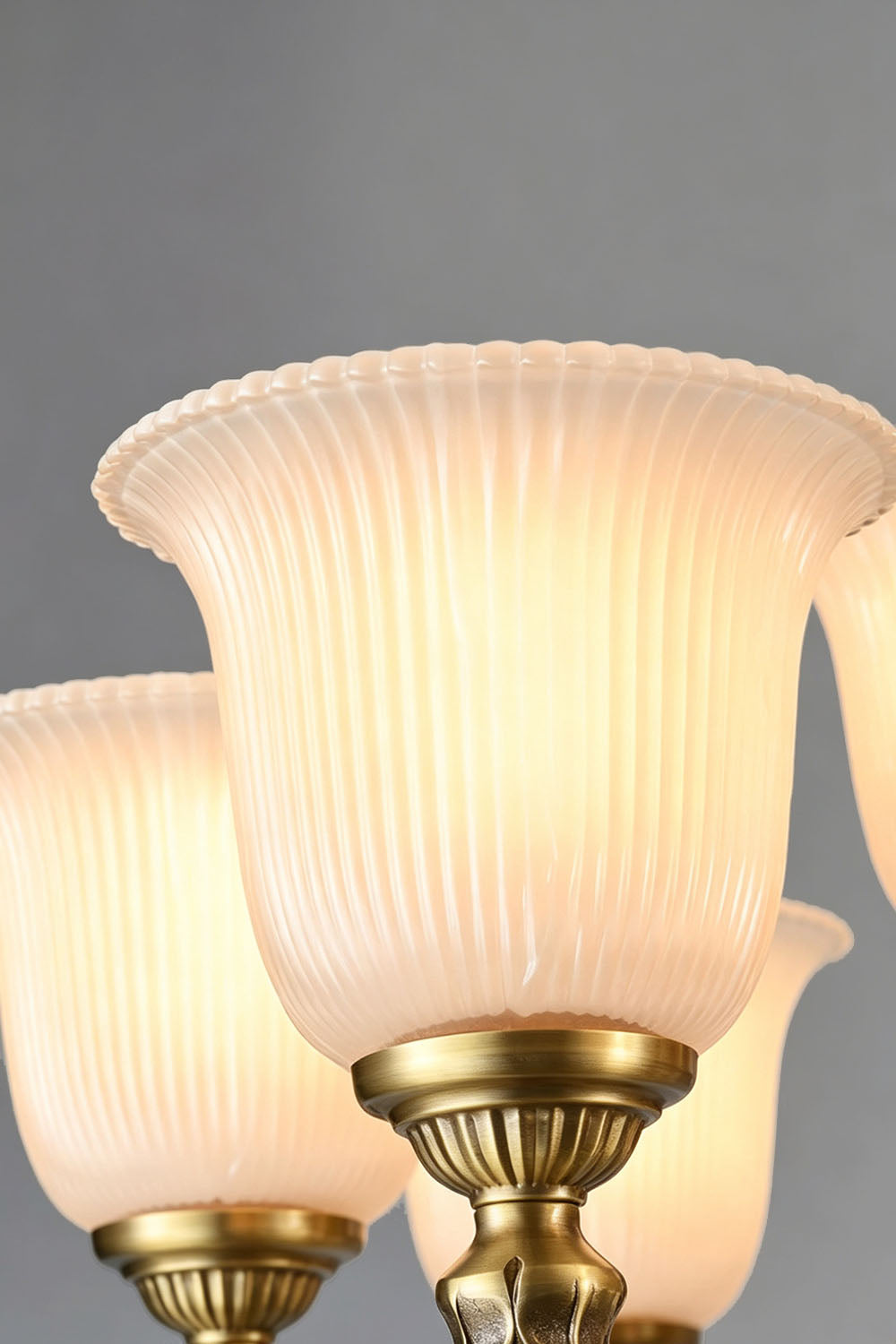 Close-up view of the beautiful glass shades of the Ormond Fluted Bell Brass Chandelier, showcasing its elegant design.