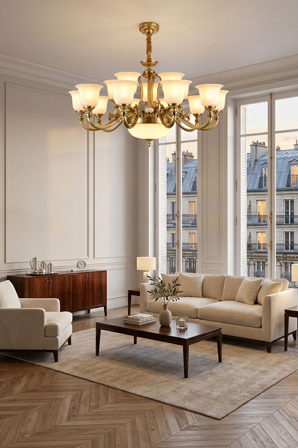 Ormond Fluted Bell Brass Chandelier illuminating a stylish living room with windows and elegant furniture.