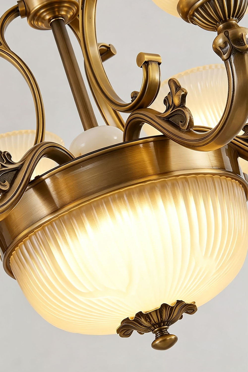 Close-up of the Ormond Fluted Bell Brass Chandelier showcasing its elegant design and light fixtures.