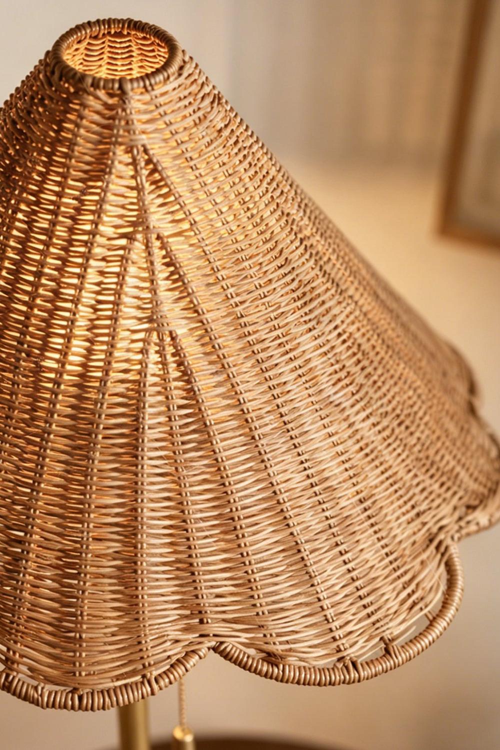 Osrilla Scalloped Rattan Table Lamp | Rattan, Brass | Macro close-up top-angled shot highlighting the intricate wavy scalloped edge and natural texture of the woven rattan conical lampshade | Detail shot | Samu Lamp
