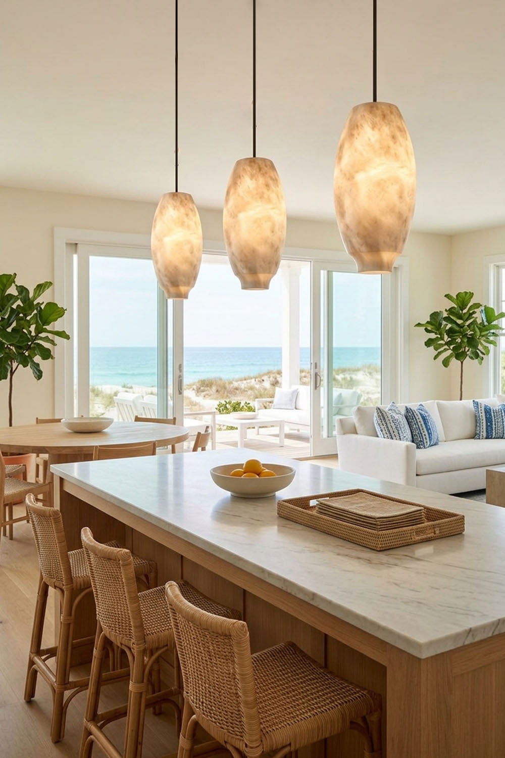 Ottilie Barrel Alabaster Pendant Light | Natural Alabaster and Metal | Trio of wide faceted pendants suspended over a marble kitchen island counter | Samu Lamp
