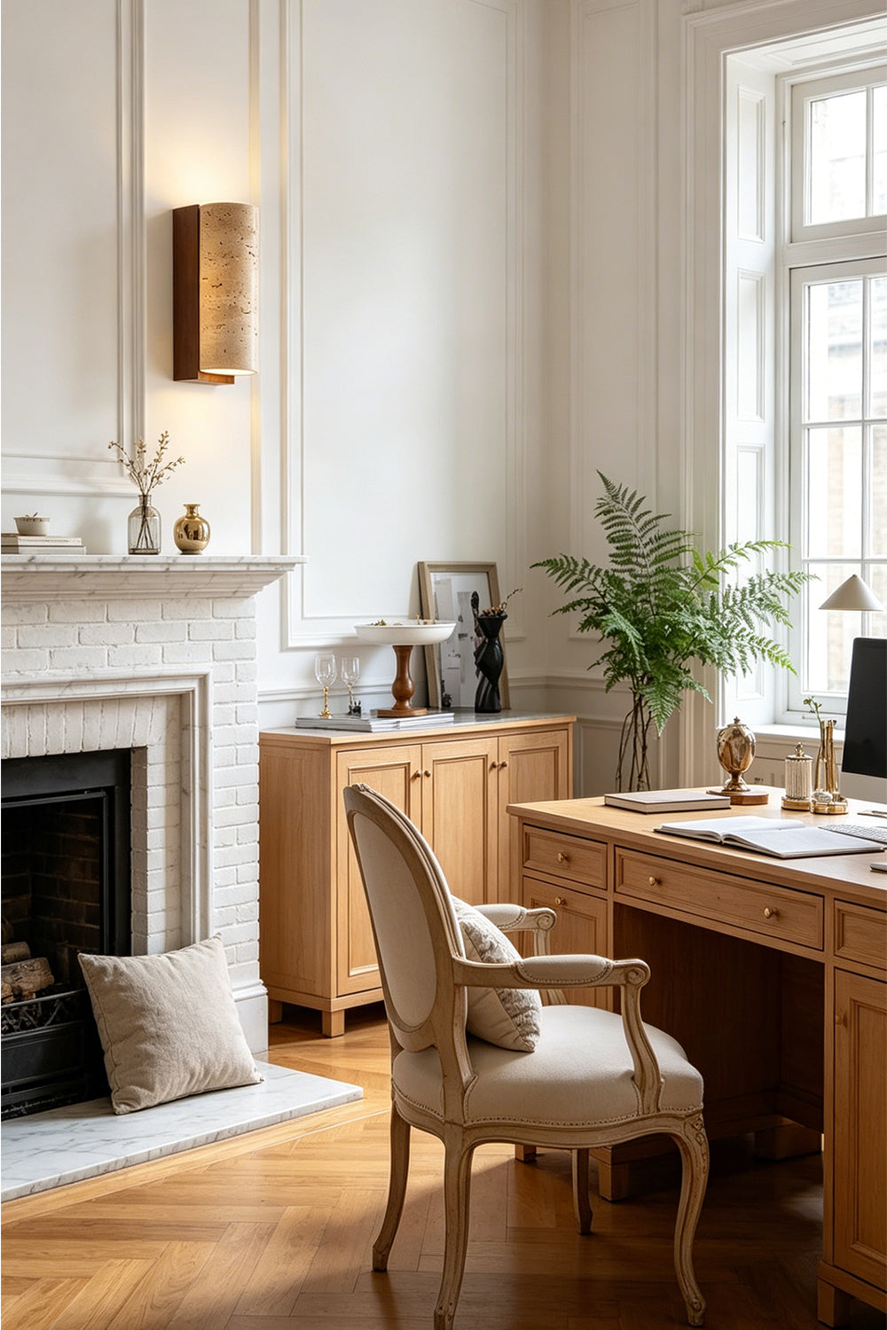 Outcrop Beige Travertine Wall Sconce | Travertine, Metal | Styled in a refined home library or study room, radiating elegant accent light next to a classical fireplace and wooden desk | Samu Lamp