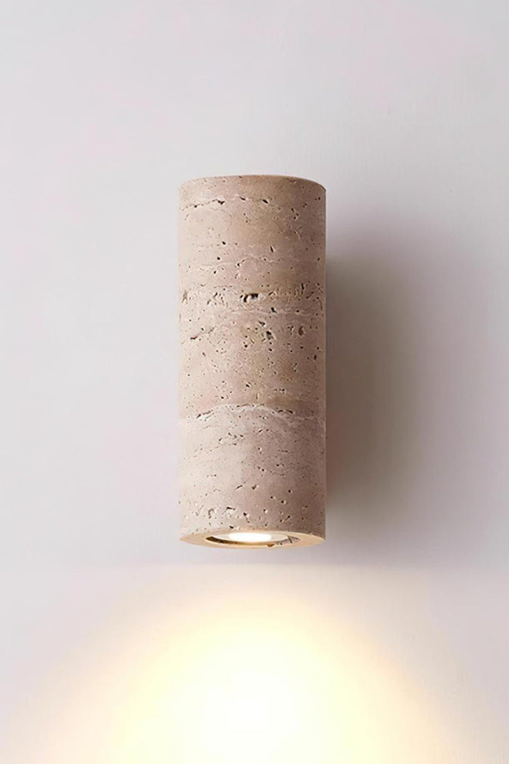Outcrop Beige Travertine Wall Sconce | Travertine, Metal | Studio front view of the fully illuminated travertine wall fixture casting a powerful warm downlight against a white background | Samu Lamp