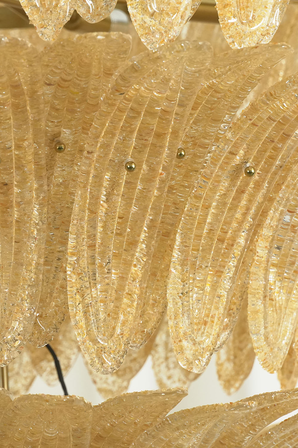Palmonde Palm Leaf Chandelier | Textured Amber Glass | Close-up of tiered palm leaf glass blades, unlit state | Samu Lamp