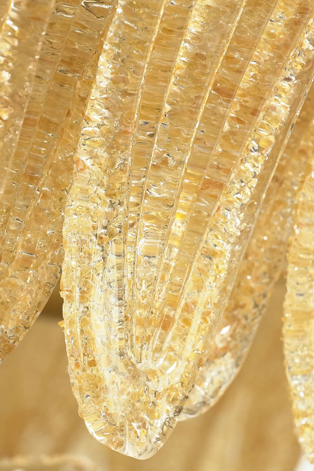 Palmonde Palm Leaf Chandelier | Textured Amber Glass | Macro view of curved tip on textured palm leaf frond | Samu Lamp