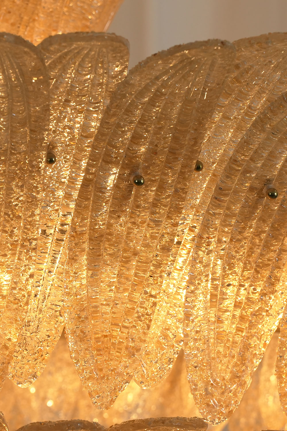 Palmonde Palm Leaf Chandelier | Seeded Amber Glass | Macro close-up of illuminated textured palm leaf fronds | Samu Lamp