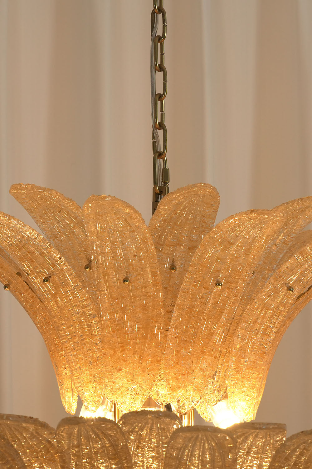 Palmonde Palm Leaf Chandelier | Amber Glass and Brass | Close-up of top flared glass crown and hanging chain | Samu Lamp