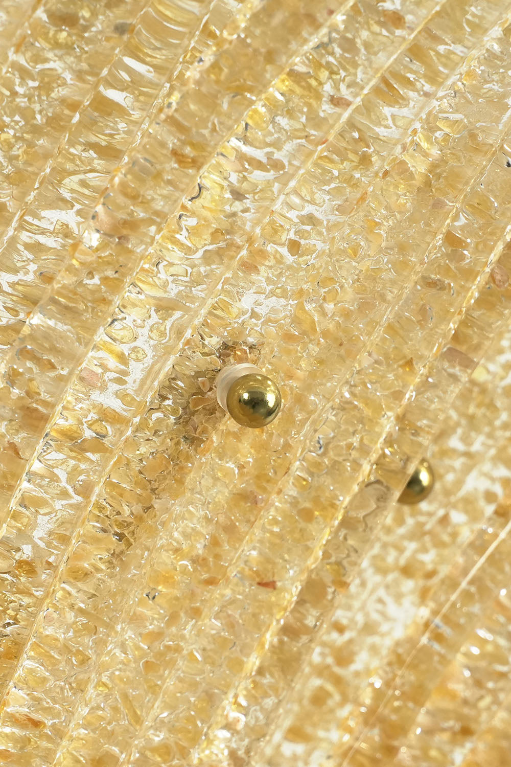 Palmonde Palm Leaf Chandelier | Brass and Amber Glass | Close-up of round brass screw caps securing glass leaf | Samu Lamp