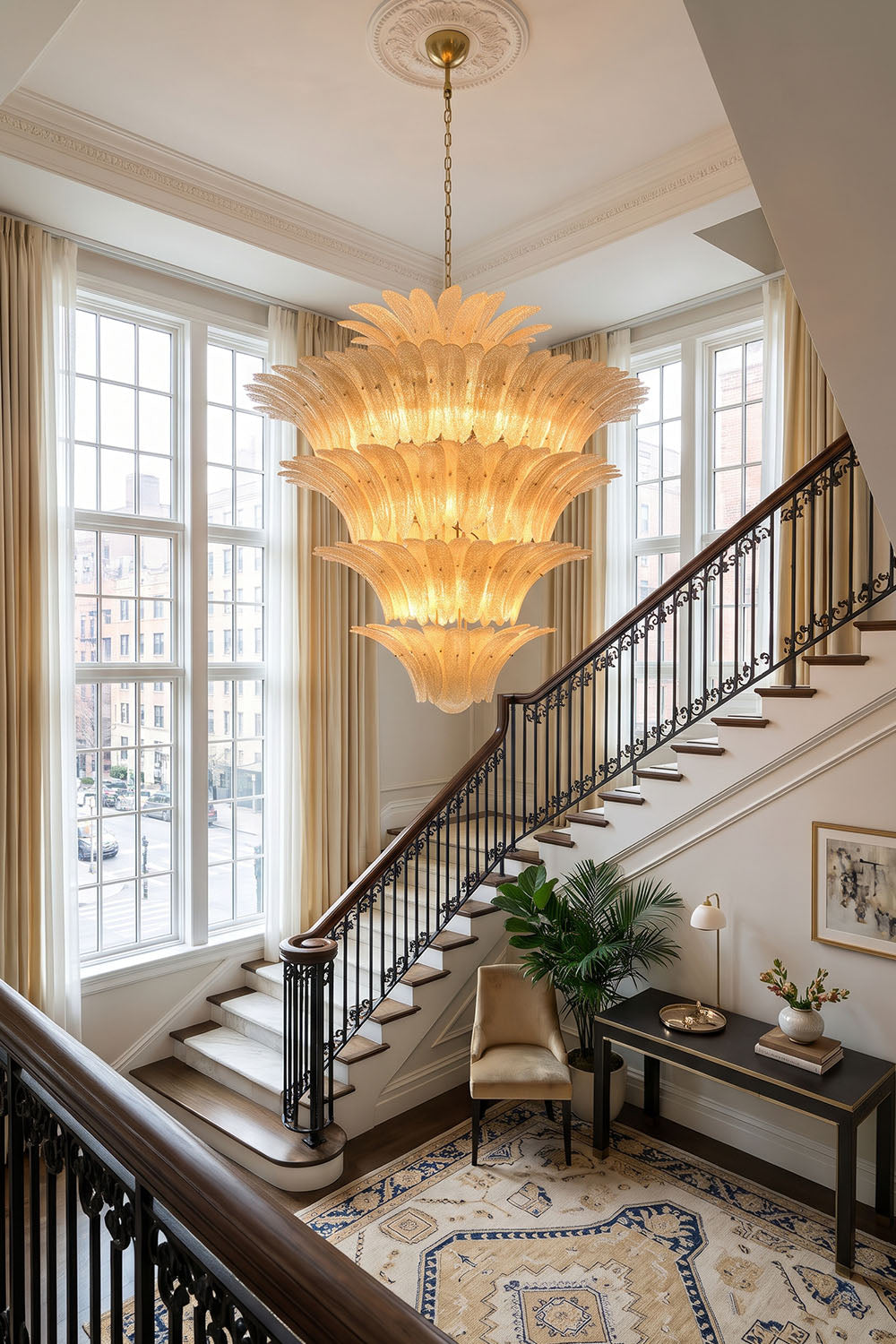 Palmonde Palm Leaf Chandelier | Amber Glass and Brass | Suspended in a grand foyer staircase with tall windows | Samu Lamp