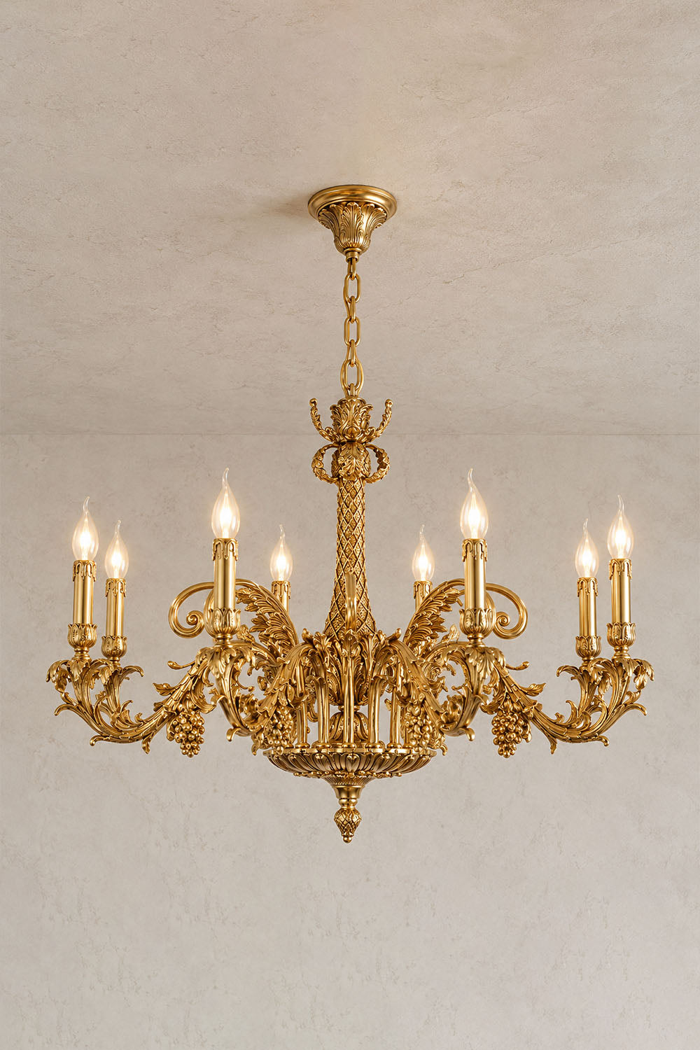 Pamprelle Brass Acanthus Grape Chandelier | Cast Brass | Variant glowing softly in a plain room | Samu Lamp