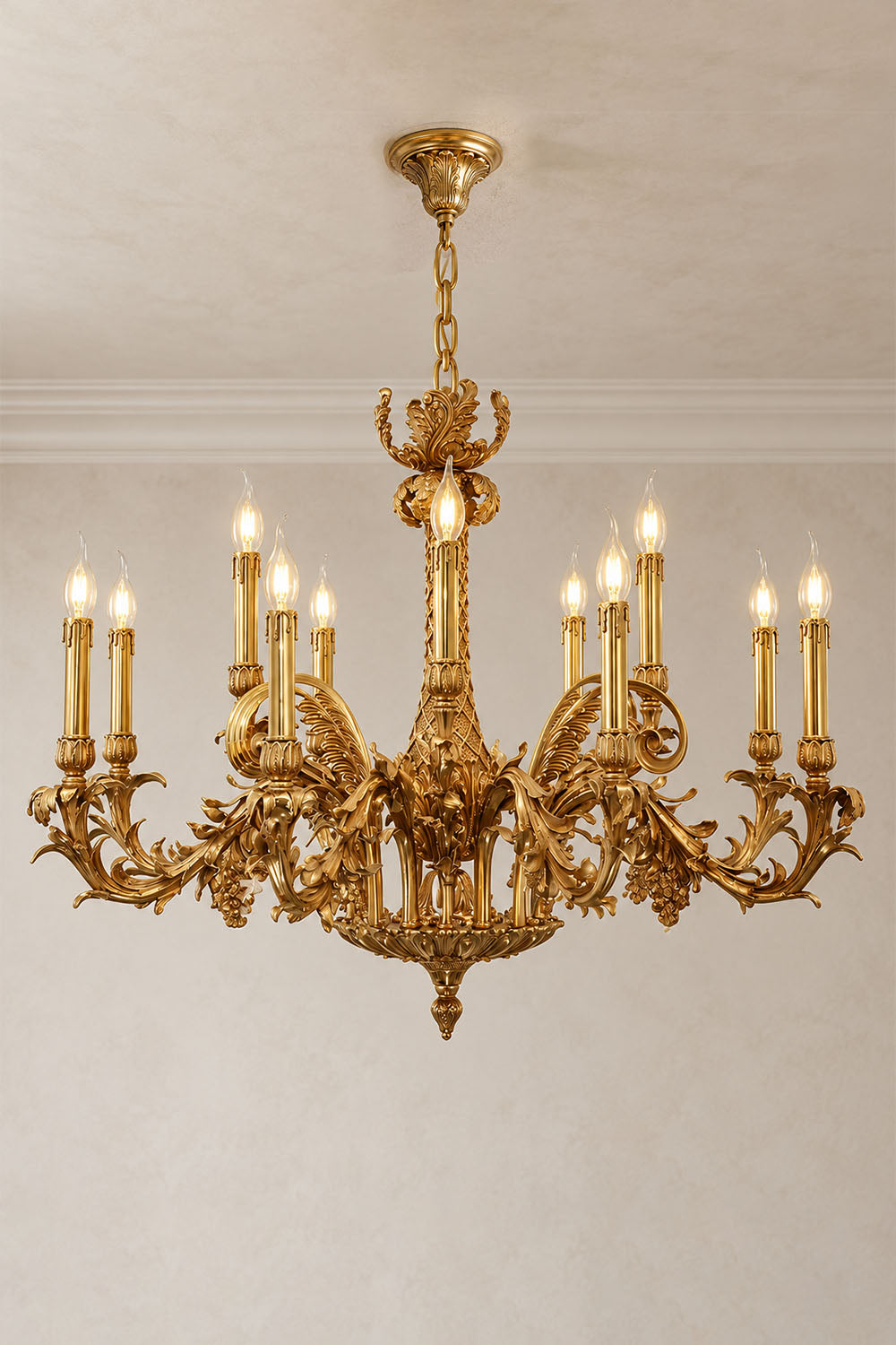 Pamprelle Brass Acanthus Grape Chandelier | Cast Brass | Large variant glowing in a plain room | Samu Lamp