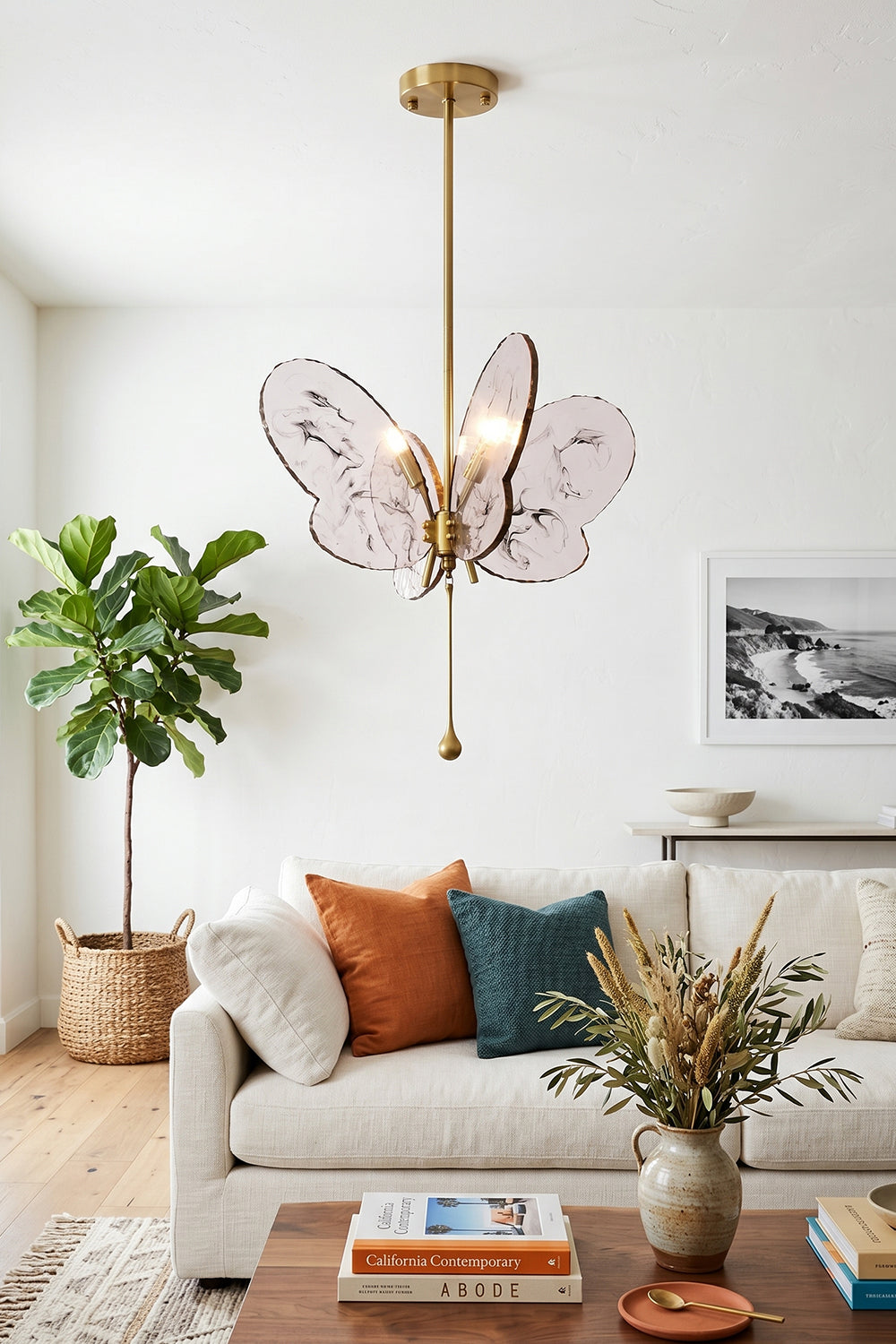 Papillon Glass Butterfly Pendant Lamp | Glass, Metal | Pink butterfly variant hanging as modern central lighting in a bright living room with a white sofa and a wooden coffee table | Samu Lamp