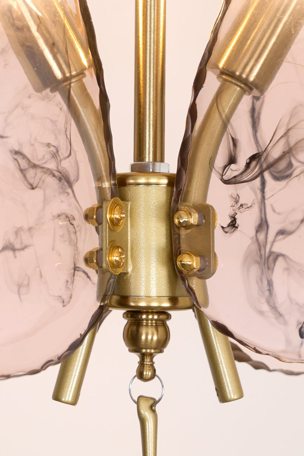 Papillon Glass Butterfly Pendant Lamp | Glass, Metal | Macro close-up focus on the gold brass central body connector and the textured veined pink glass wings | Detail shot | Samu Lamp