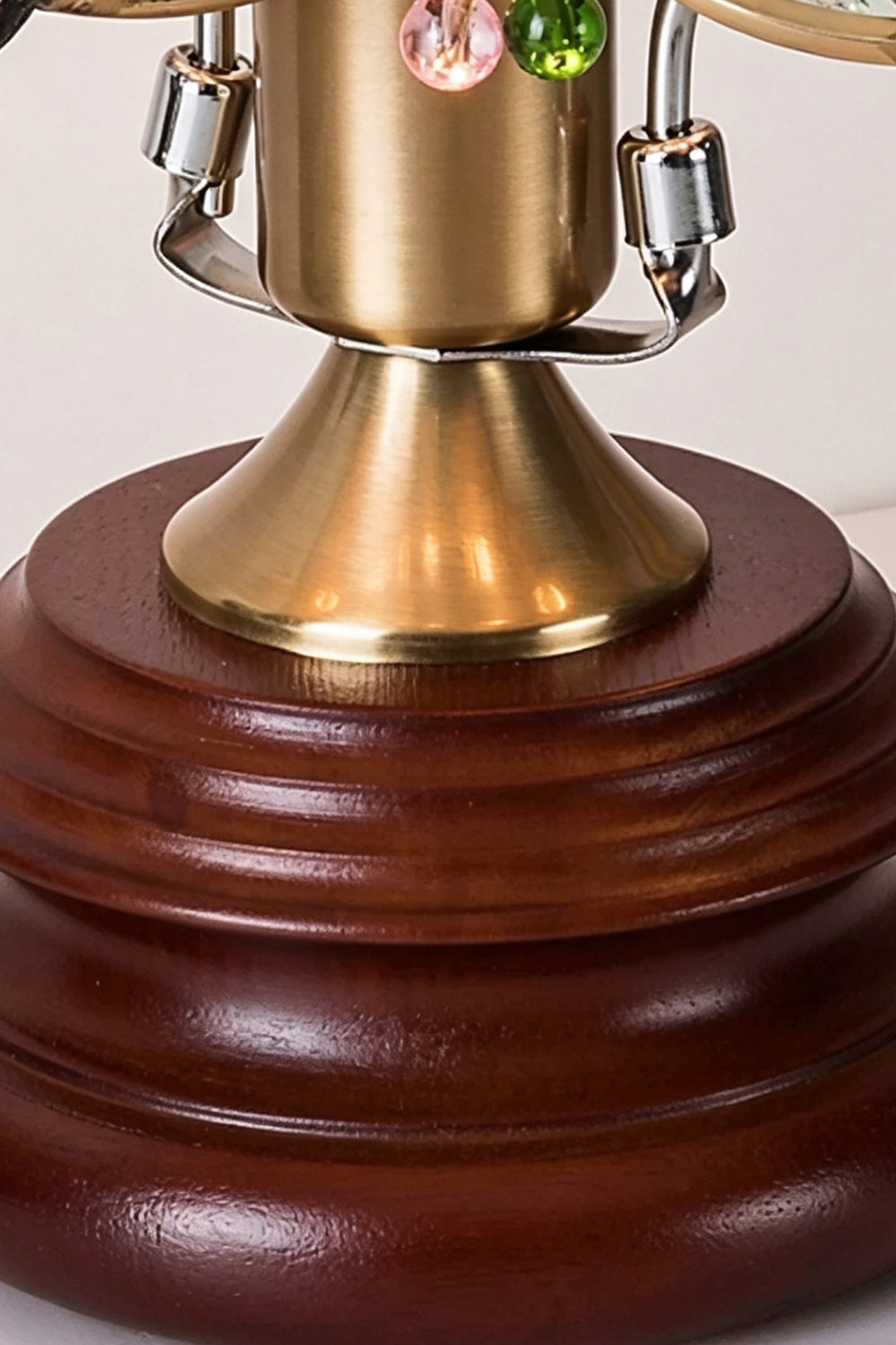 Papillon Heirloom Stained Table Lamp | Wood, Glass, Metal | Close-up focus on the brushed brass neck connector and the tiered, turned dark wood pedestal base | Detail shot | Samu Lamp