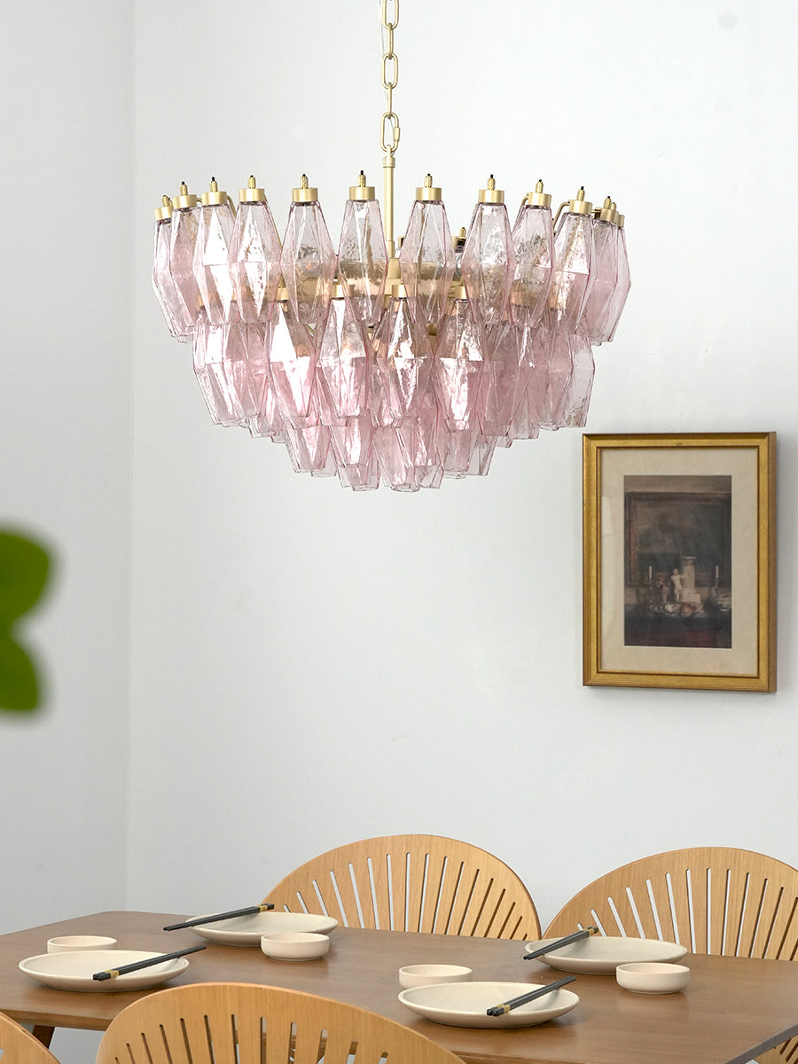 Modern pink glass tiered pendant light | Metal, Glass | Centered in a dining room with white walls and wood furniture | Samu Lamp
