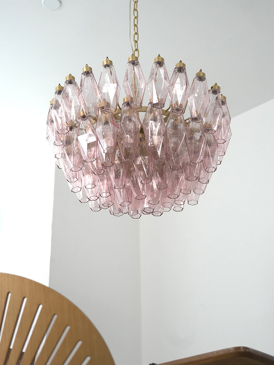 Pink art glass tiered chandelier in a modern hallway | Metal, Glass | High-ceiling installation over a corner seat | Samu Lamp
