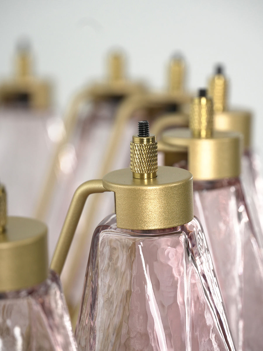 Detailed shot of brass hooks and pink glass attachment | Metal, Glass | Focusing on the faceted glass surface | Samu Lamp