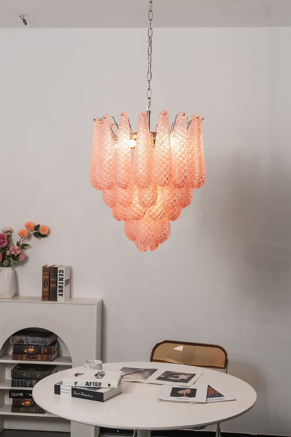 Amara Blush Cascading Glass Chandelier | Glass, Metal | Hanging over a small round white table and chair in a minimalist residential corner | Samu Lamp