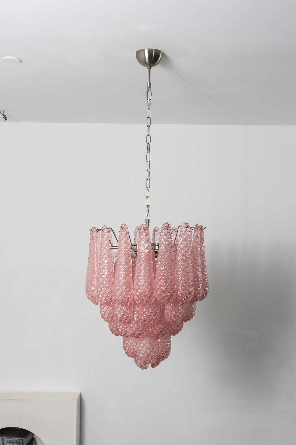 Amara Blush Cascading Glass Chandelier | Glass, Metal | Full tiered view of the illuminated pink glass chandelier casting soft ambient light against a studio backdrop | Samu Lamp