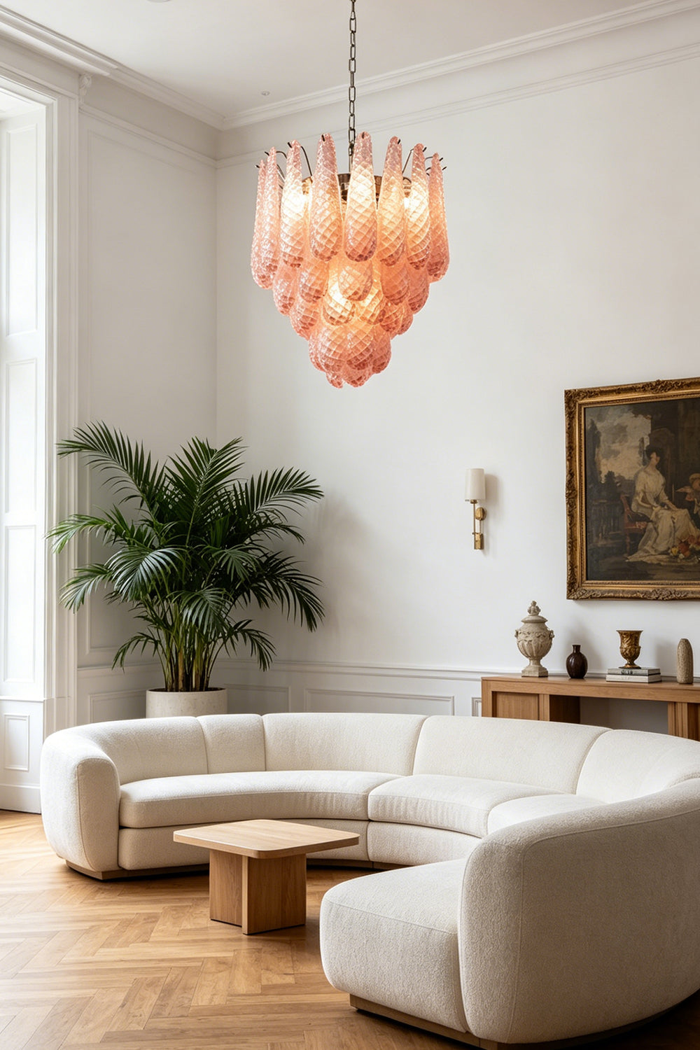 Amara Blush Cascading Glass Chandelier | Glass, Metal | Illuminating a contemporary living room with a curved cream sofa and a wooden coffee table | Samu Lamp