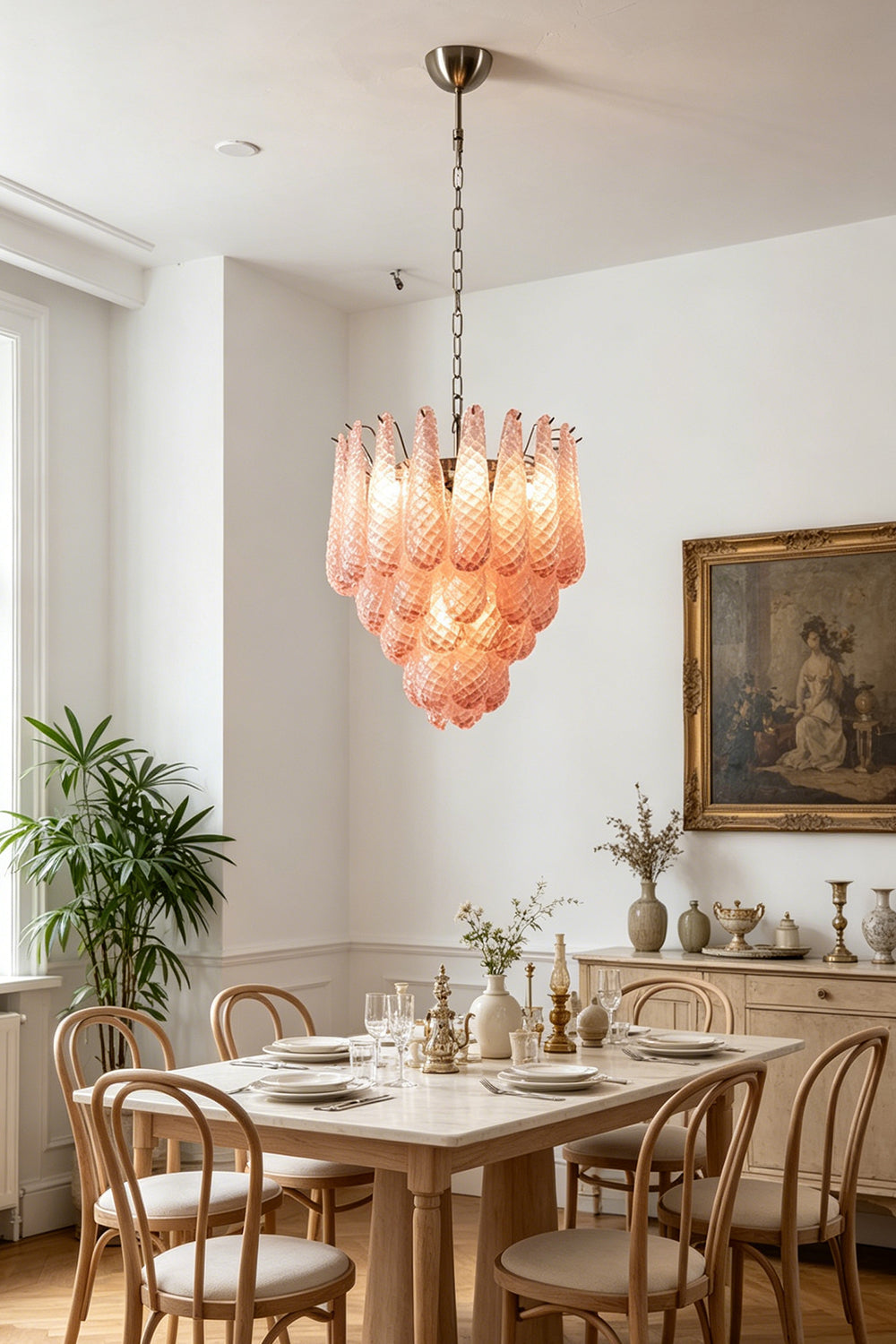 Amara Blush Cascading Glass Chandelier | Glass, Metal | Suspended over a wooden dining table and chairs in a bright, classically styled dining room | Samu Lamp
